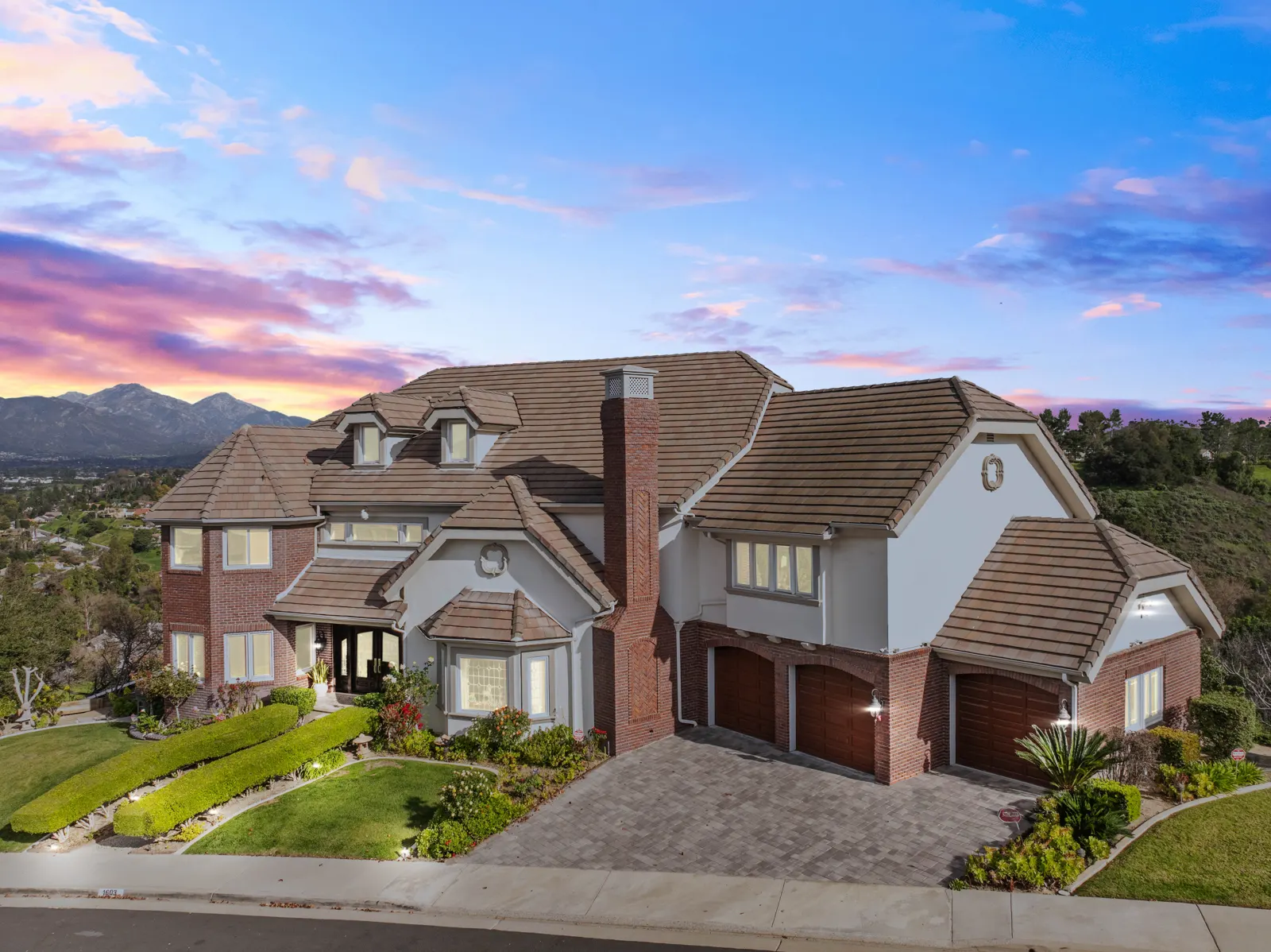 Estate exterior at twilight with mountain backdrop